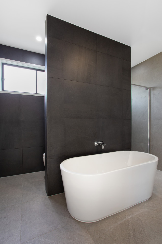 Design ideas for a mid-sized master bathroom in Brisbane with furniture-like cabinets, black cabinets, a freestanding tub, an alcove shower, black tile, porcelain tile, porcelain floors, a vessel sink, engineered quartz benchtops, grey floor, a hinged shower door, yellow benchtops, a double vanity and a floating vanity.