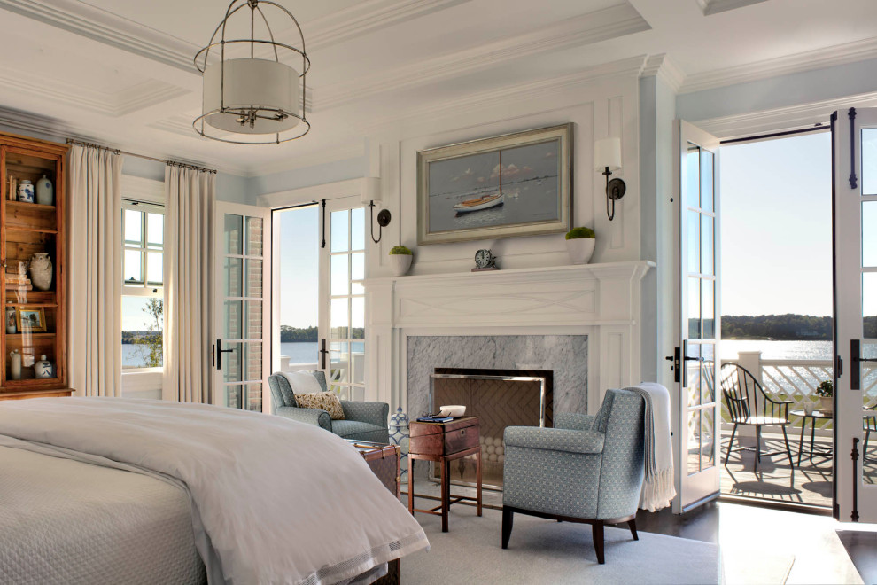 Inspiration for an expansive traditional master bedroom in Baltimore with white walls, dark hardwood floors, a standard fireplace, a stone fireplace surround, brown floor and coffered.