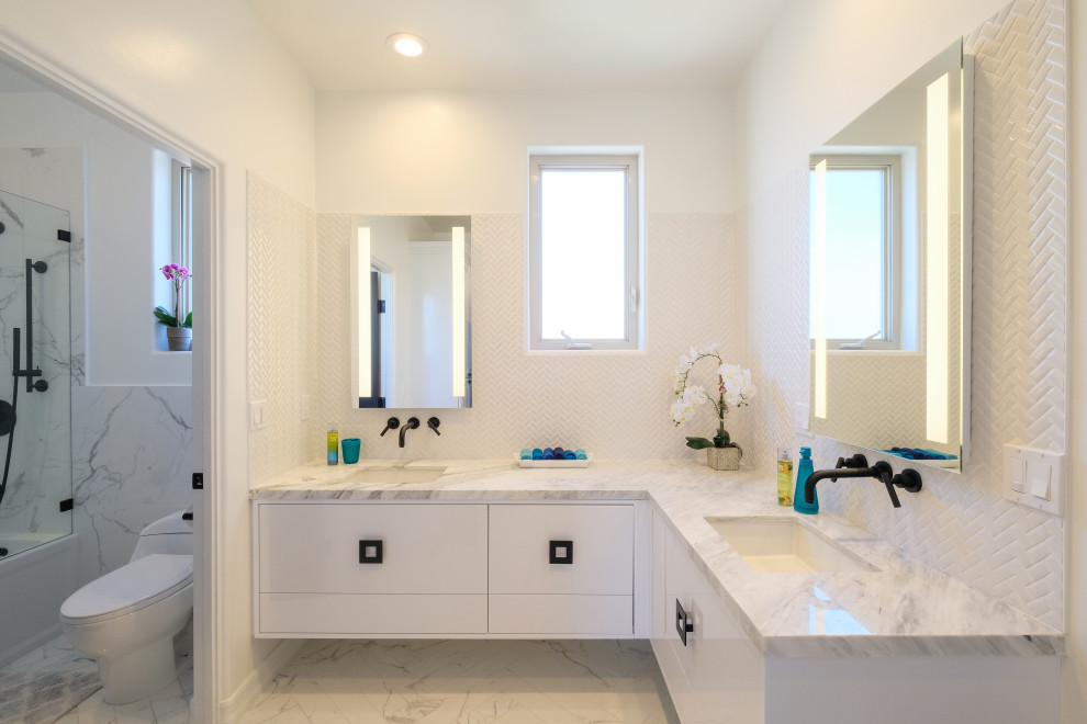 This is an example of a large contemporary master bathroom in San Diego with flat-panel cabinets, white cabinets, an alcove tub, a shower/bathtub combo, a one-piece toilet, mosaic tile, white walls, marble floors, an undermount sink, marble benchtops, white floor, an open shower, white benchtops, a double vanity and a floating vanity.