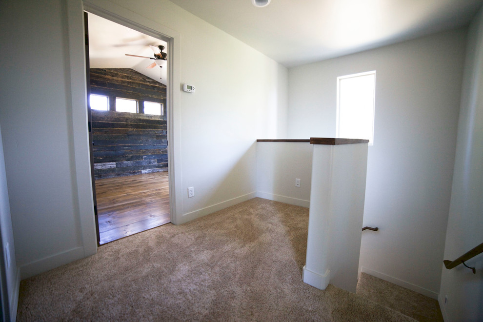 Inspiration for a small rustic carpeted hallway remodel in Phoenix with gray walls