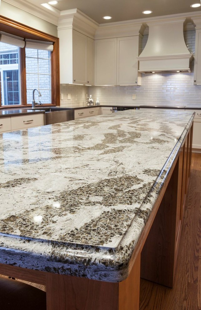 Inspiration for a large transitional light wood floor kitchen pantry remodel in Cleveland with white backsplash, glass tile backsplash, stainless steel appliances and an island