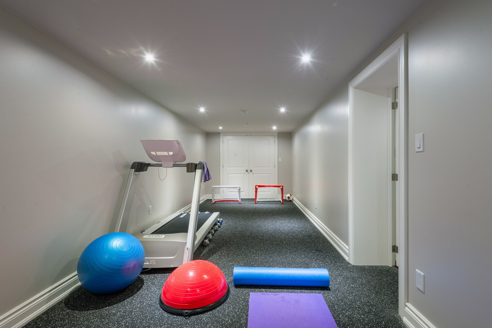 This is an example of a small transitional multipurpose gym in Toronto with grey walls, vinyl floors and multi-coloured floor.