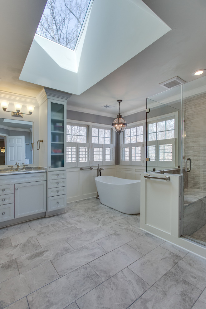 Large transitional master bathroom in DC Metro with recessed-panel cabinets, white cabinets, a freestanding tub, a corner shower, an undermount sink and granite benchtops.