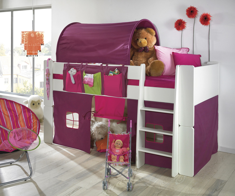 This is an example of a contemporary kids' bedroom for kids 4-10 years old and girls in Other with white walls and laminate floors.
