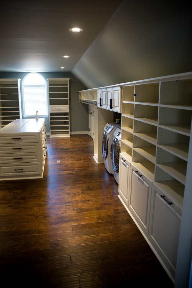 Inspiration for a large transitional gender-neutral medium tone wood floor and brown floor walk-in closet remodel in Atlanta with raised-panel cabinets and white cabinets