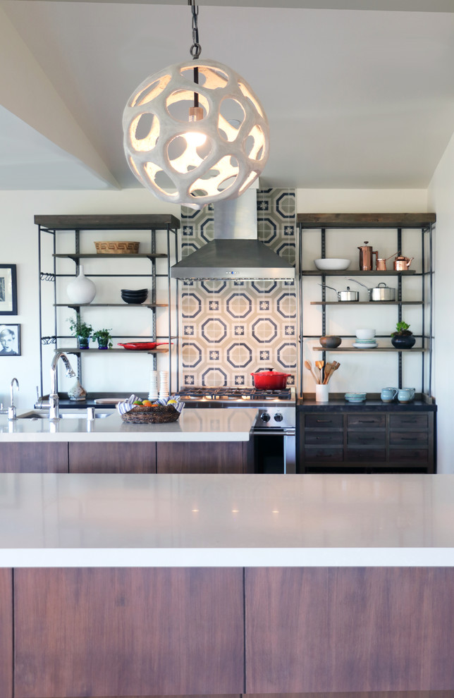 Inspiration for a large eclectic u-shaped open plan kitchen in Los Angeles with an undermount sink, flat-panel cabinets, medium wood cabinets, quartz benchtops, beige splashback, cement tile splashback, stainless steel appliances, medium hardwood floors, multiple islands and brown floor.