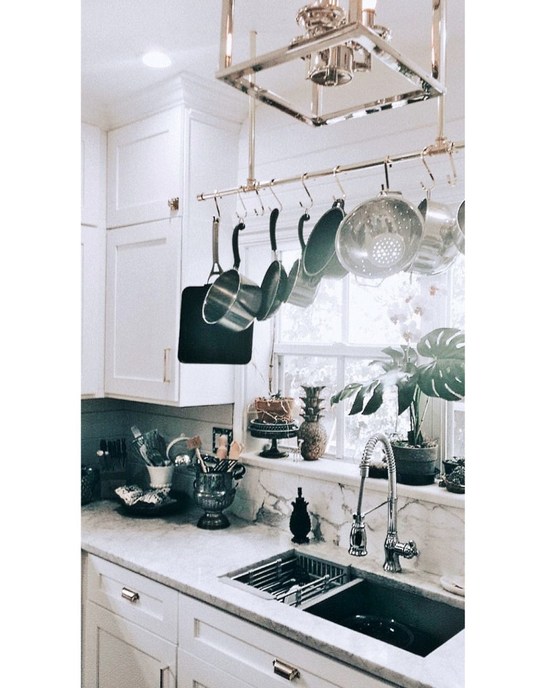 Example of a small enclosed kitchen design with an undermount sink, shaker cabinets, white cabinets, marble countertops, white backsplash, marble backsplash, stainless steel appliances and no island