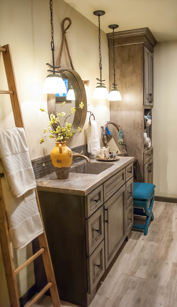 Mid-sized country master bathroom in New York with an integrated sink, raised-panel cabinets, distressed cabinets, concrete benchtops, an open shower, a one-piece toilet, beige tile, porcelain tile, yellow walls and ceramic floors.