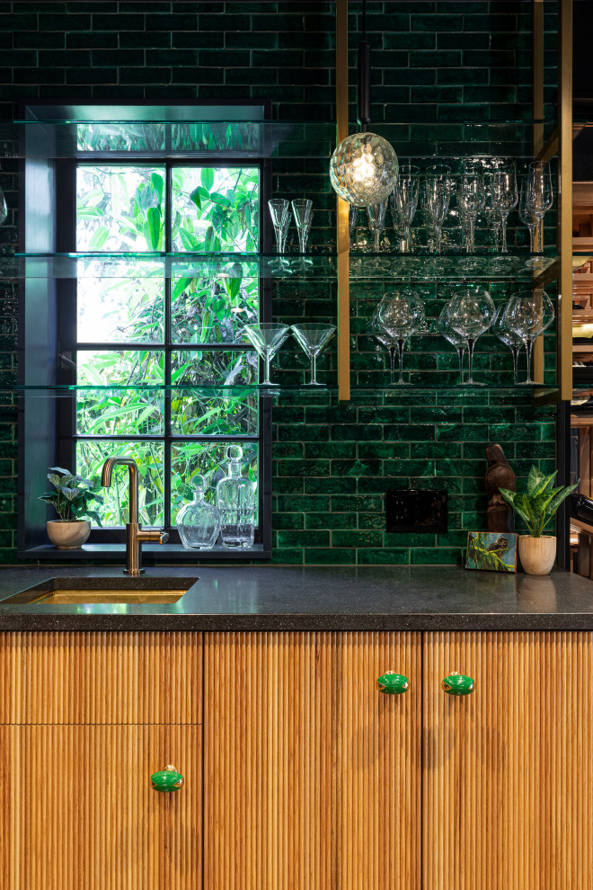 Inspiration for a large eclectic single-wall wet bar in Portland with an undermount sink, flat-panel cabinets, light wood cabinets, quartz benchtops, green splashback, ceramic splashback, concrete floors, grey floor and grey benchtop.