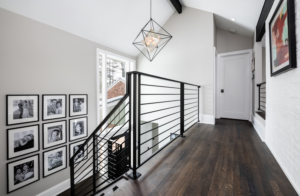 Inspiration for a mid-sized contemporary hallway in DC Metro with grey walls, dark hardwood floors and brown floor.