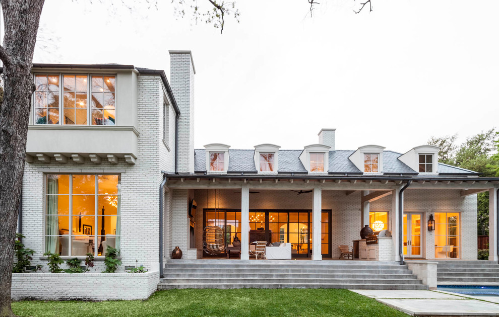 Inspiration for a transitional two-storey brick white exterior in Dallas.