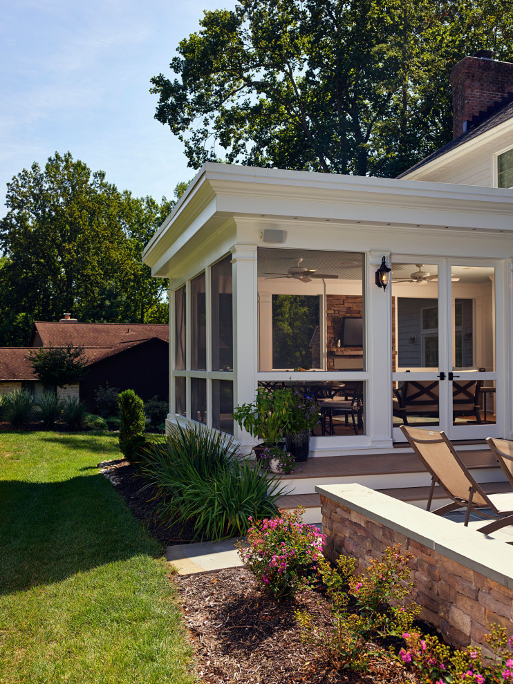 Large transitional stone screened-in back porch idea in Baltimore with a roof extension