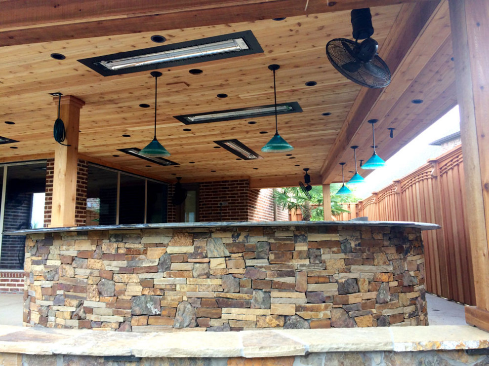 Design ideas for a transitional backyard patio in Dallas with an outdoor kitchen and a roof extension.
