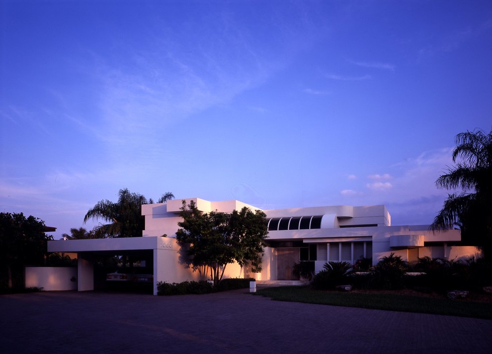 Photo of a mid-sized contemporary two-storey stucco white exterior in Miami with a flat roof.