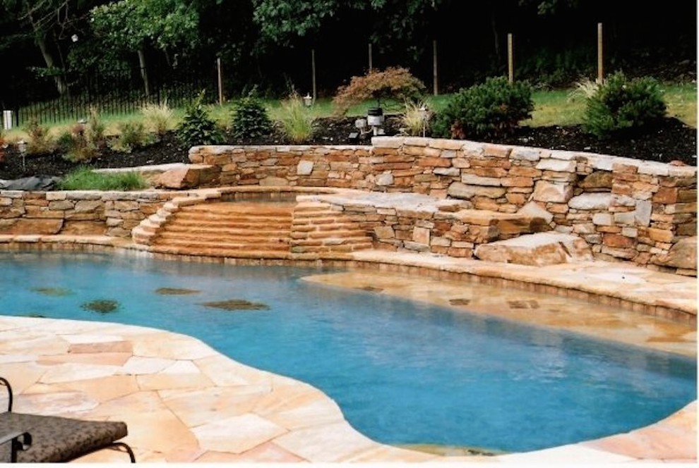 Hot tub - mid-sized backyard stone and custom-shaped lap hot tub idea in Baltimore