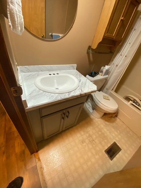 Example of a large l-shaped eat-in kitchen design with a drop-in sink, flat-panel cabinets, gray cabinets, laminate countertops, no island and white countertops
