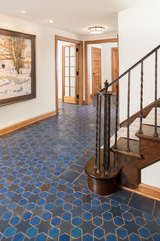 Photo of a large mediterranean hallway in Minneapolis with white walls, ceramic floors and blue floor.