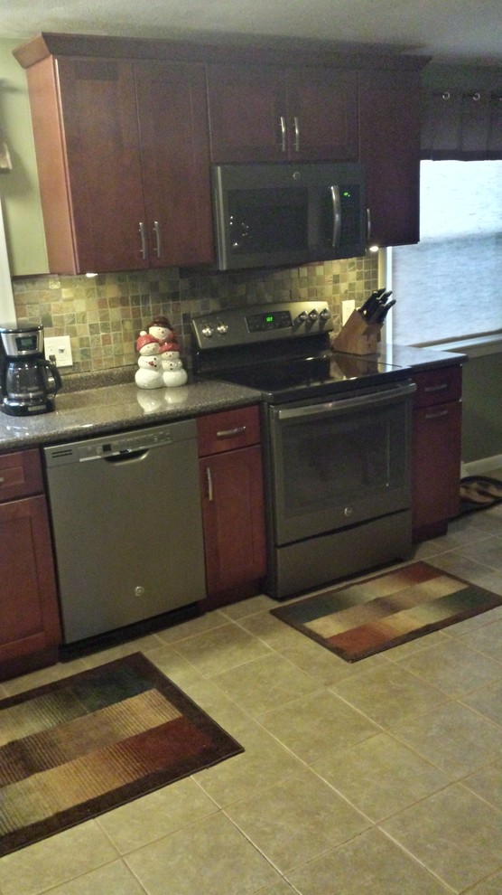 Example of a mid-sized transitional l-shaped eat-in kitchen design in Miami with a drop-in sink, recessed-panel cabinets, medium tone wood cabinets, granite countertops, beige backsplash, subway tile backsplash, stainless steel appliances and no island