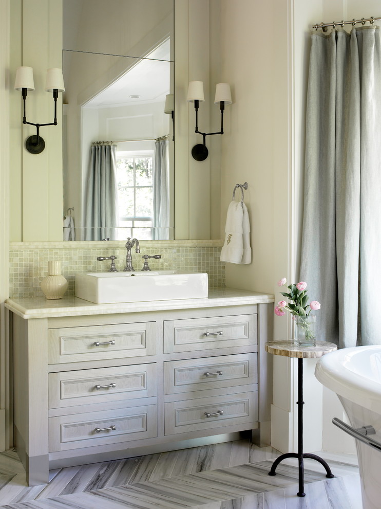 Traditional bathroom in Atlanta with a freestanding tub and mosaic tile.