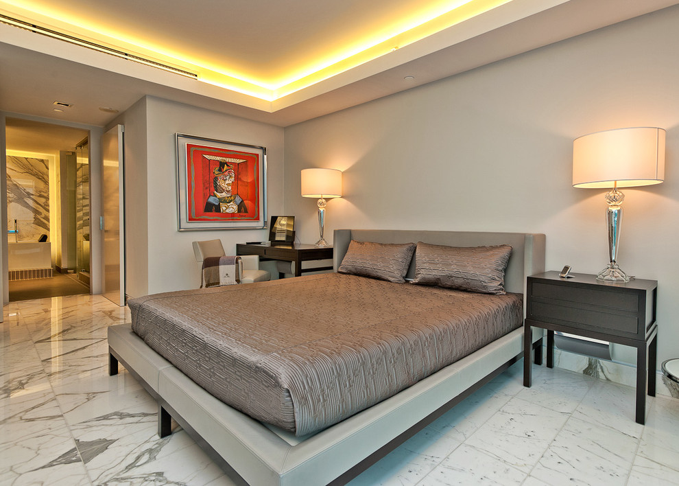 This is an example of a mid-sized contemporary master bedroom in Miami with grey walls, marble floors and no fireplace.