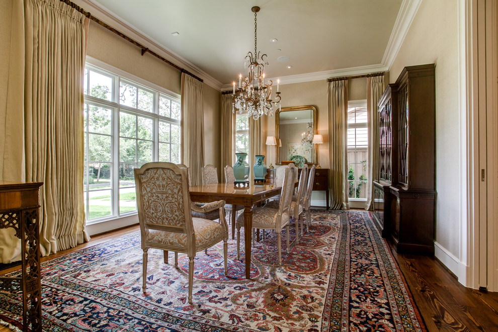 This is an example of a large traditional separate dining room in Dallas with brown walls, dark hardwood floors, no fireplace and brown floor.
