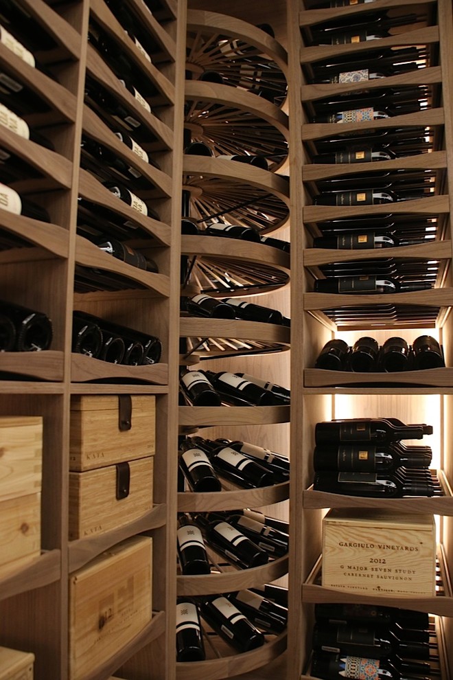 Large transitional wine cellar photo with display racks