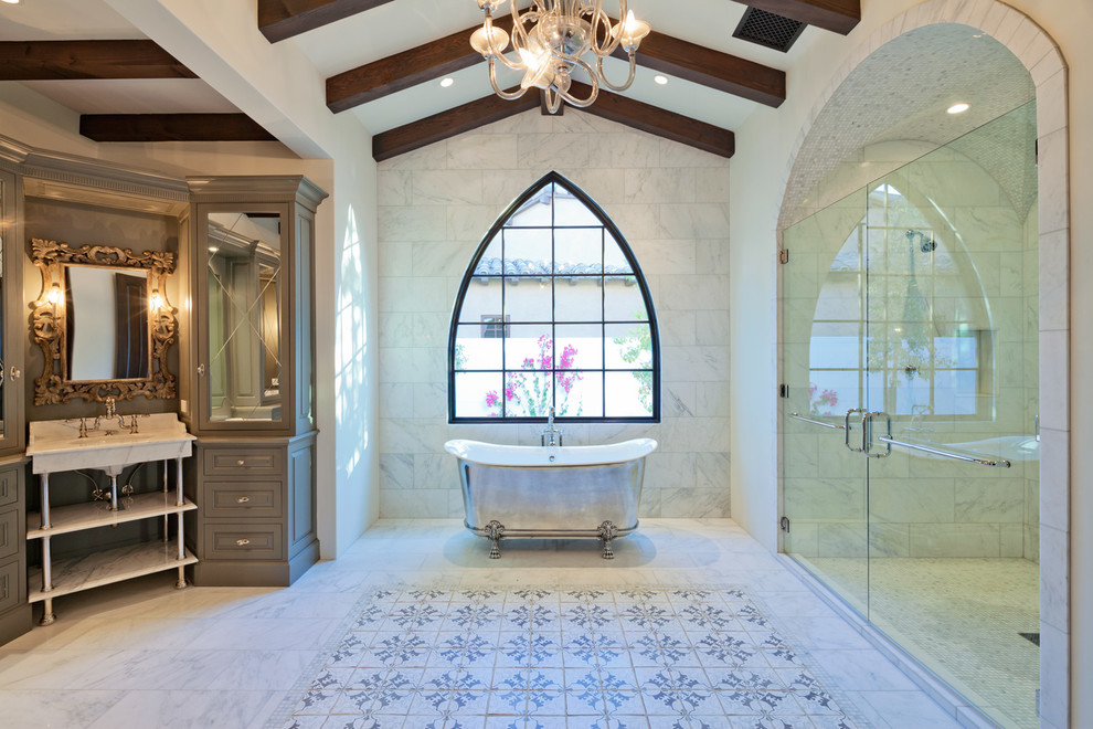 Design ideas for a mediterranean master bathroom in Phoenix with raised-panel cabinets, grey cabinets, a claw-foot tub, an alcove shower and white tile.