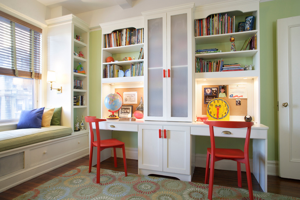 Inspiration for a mid-sized transitional kids' study room for kids 4-10 years old and boys in New York with green walls and medium hardwood floors.