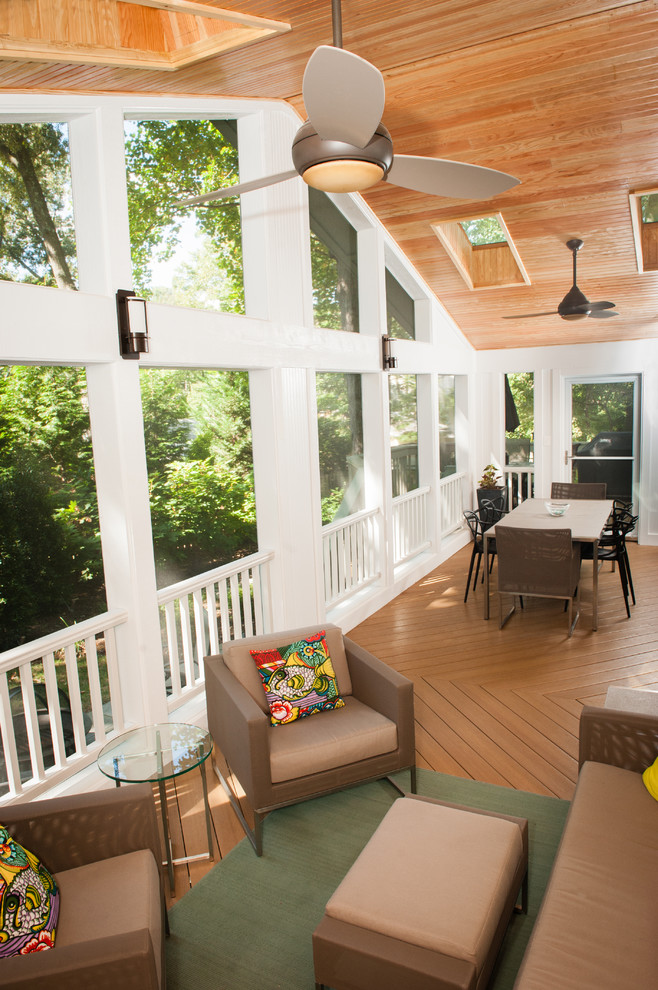 Photo of a large contemporary screened-in verandah in DC Metro with decking and a roof extension.