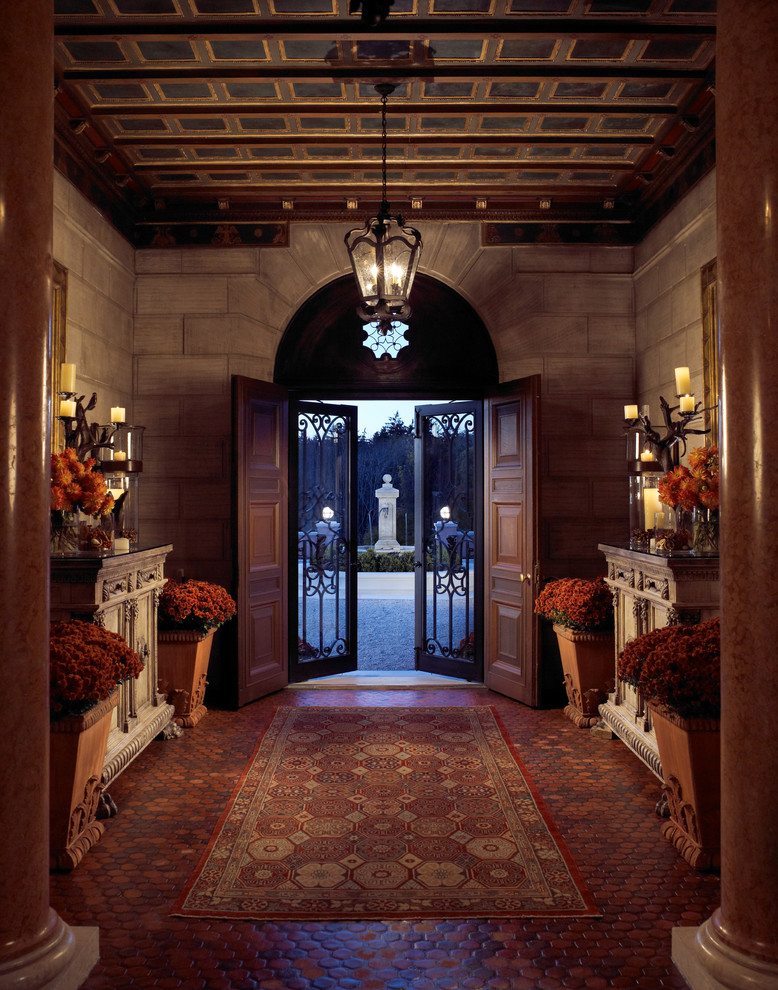 Traditional foyer in New York with a double front door and a brown front door.