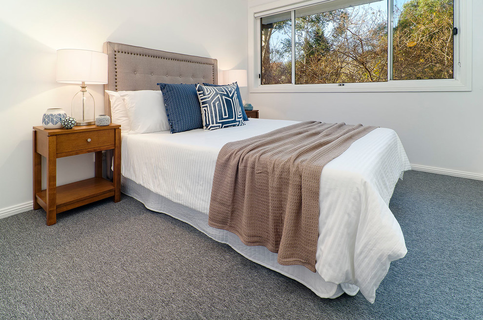 Photo of a mid-sized contemporary guest bedroom in Sydney with grey walls, carpet, no fireplace and grey floor.