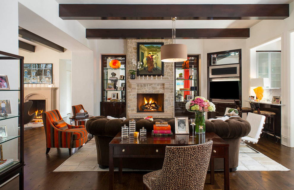 This is an example of a transitional living room in Dallas with white walls, dark hardwood floors, a standard fireplace and a stone fireplace surround.