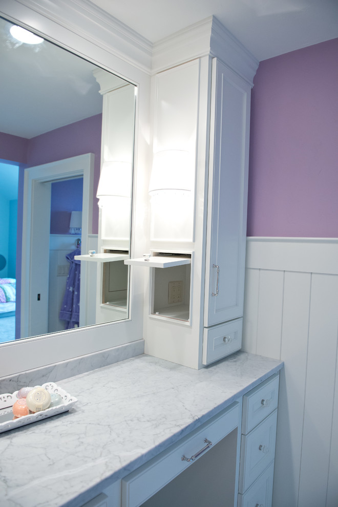Photo of a large country bathroom in Milwaukee with recessed-panel cabinets, white cabinets, pink walls, ceramic floors, an undermount sink, engineered quartz benchtops and white floor.