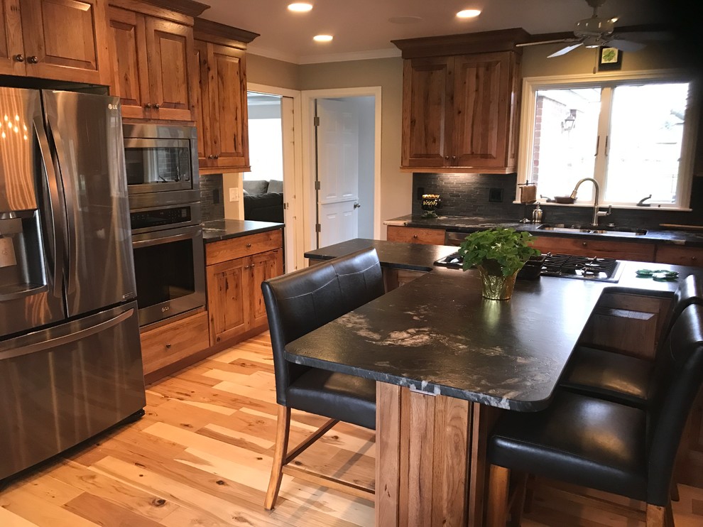 Eat-in kitchen - mid-sized rustic l-shaped eat-in kitchen idea with an undermount sink, raised-panel cabinets, medium tone wood cabinets, granite countertops and an island