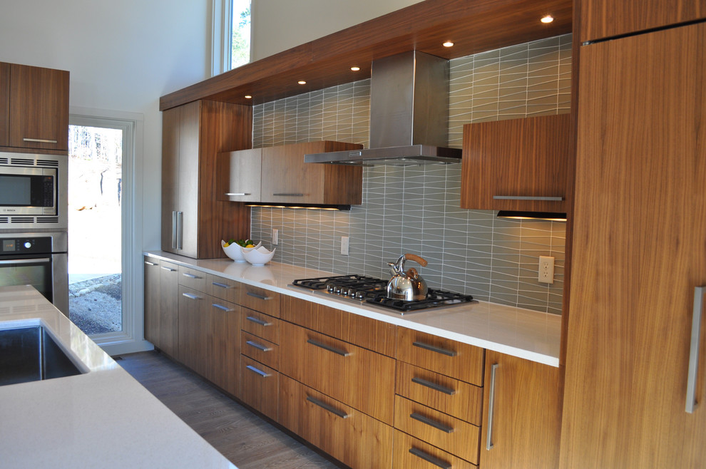 This is an example of a contemporary l-shaped open plan kitchen in Other with flat-panel cabinets, medium wood cabinets, grey splashback and with island.