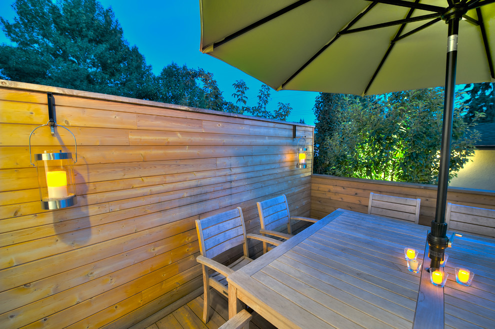 This is an example of a small contemporary backyard deck in Calgary.