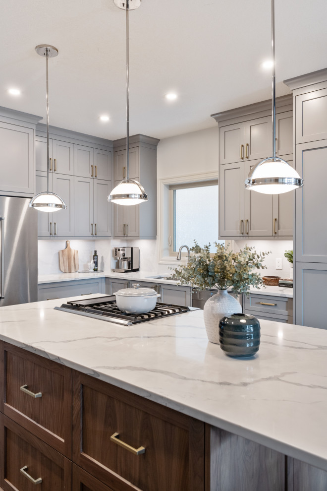 Mid-sized contemporary l-shaped eat-in kitchen in Calgary with an undermount sink, shaker cabinets, grey cabinets, quartz benchtops, white splashback, porcelain splashback, stainless steel appliances, slate floors, with island, multi-coloured floor and white benchtop.