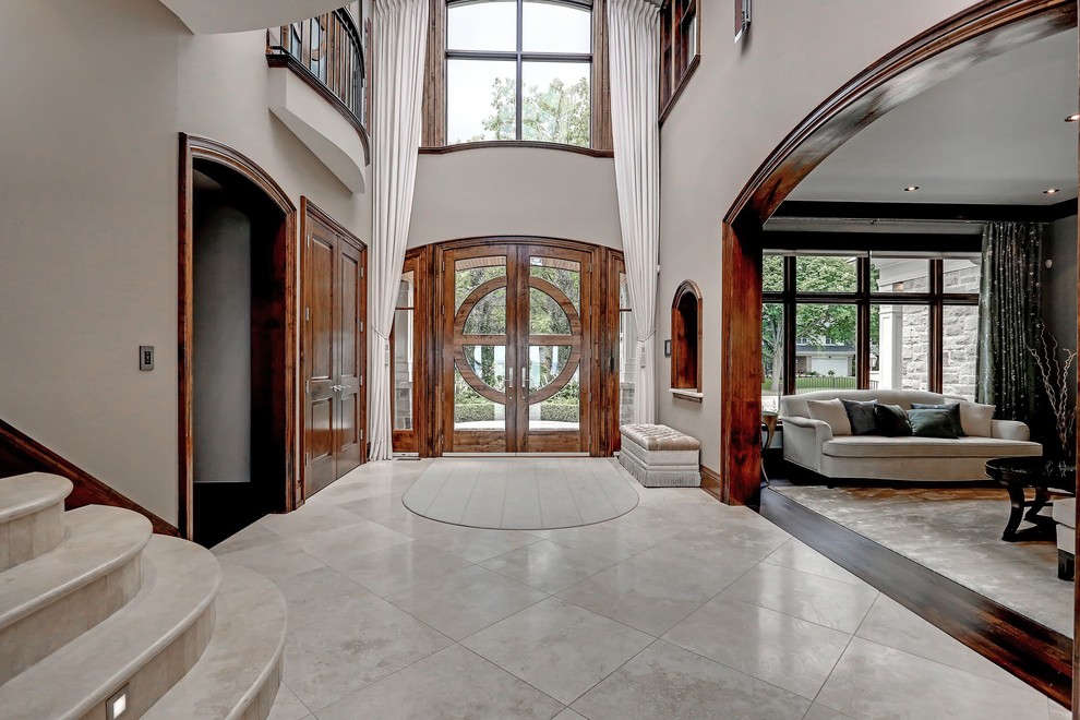 Foyer - transitional porcelain tile foyer idea in Toronto with gray walls and a medium wood front door