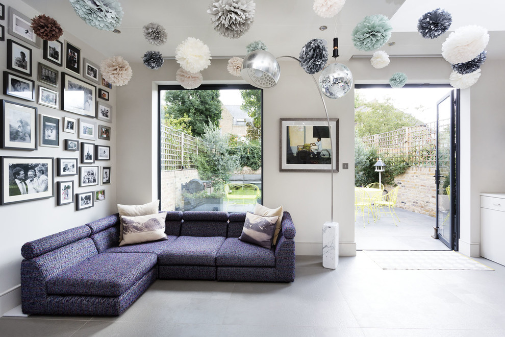 This is an example of a contemporary family room in London with grey floor and beige walls.