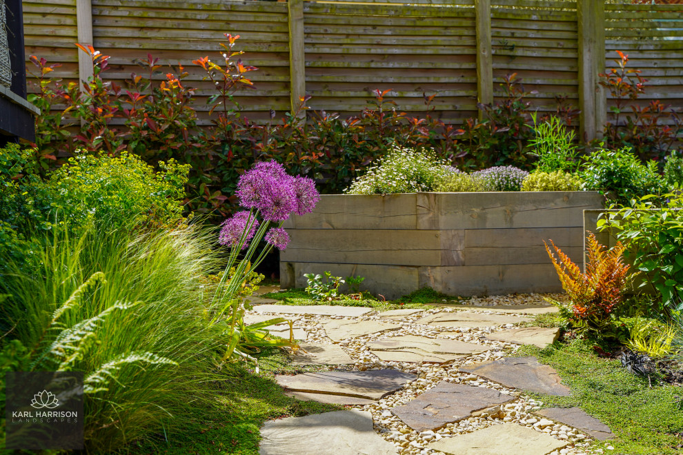 Geometrischer, Mittelgroßer Skandinavischer Garten im Sommer, hinter dem Haus mit Blumenbeet, direkter Sonneneinstrahlung, Dielen und Holzzaun in Buckinghamshire