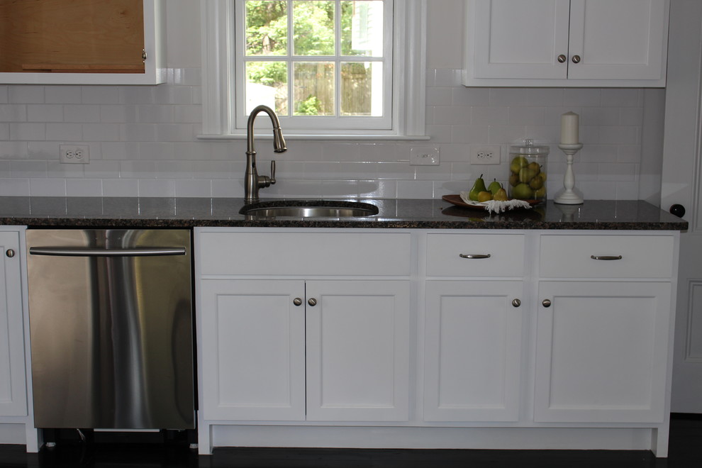 Inspiration for a mid-sized transitional l-shaped separate kitchen in Boston with an undermount sink, recessed-panel cabinets, white cabinets, granite benchtops, white splashback, subway tile splashback, stainless steel appliances, medium hardwood floors and no island.