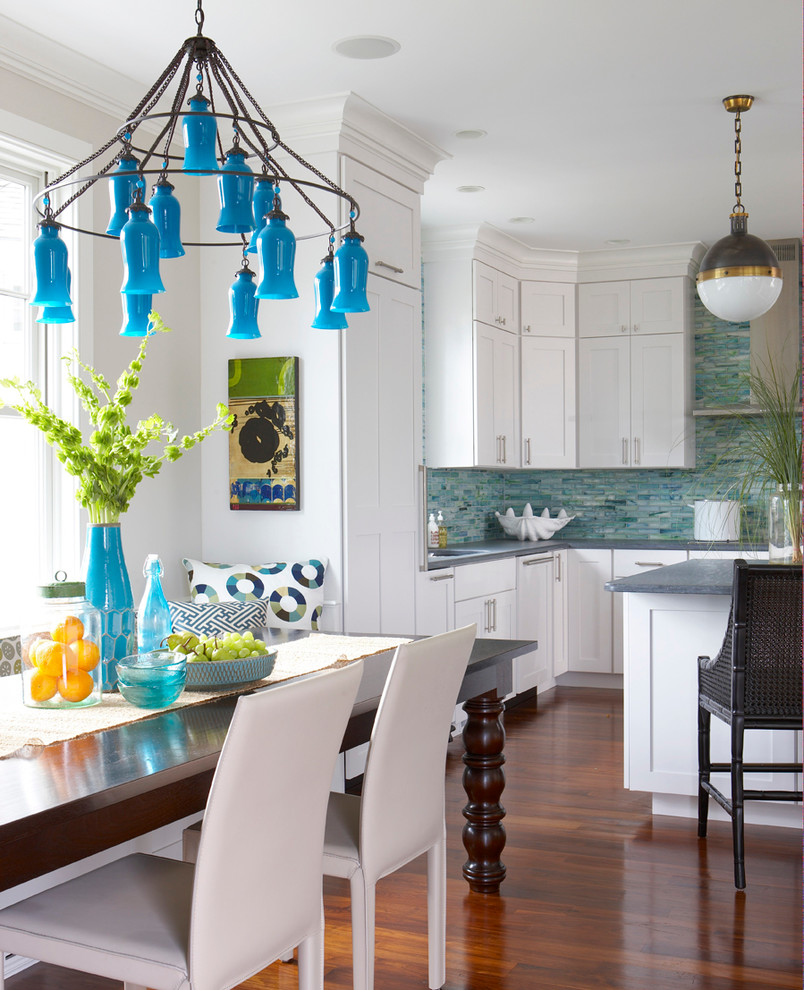 Photo of a beach style u-shaped eat-in kitchen in Boston with shaker cabinets, white cabinets, blue splashback, medium hardwood floors and with island.