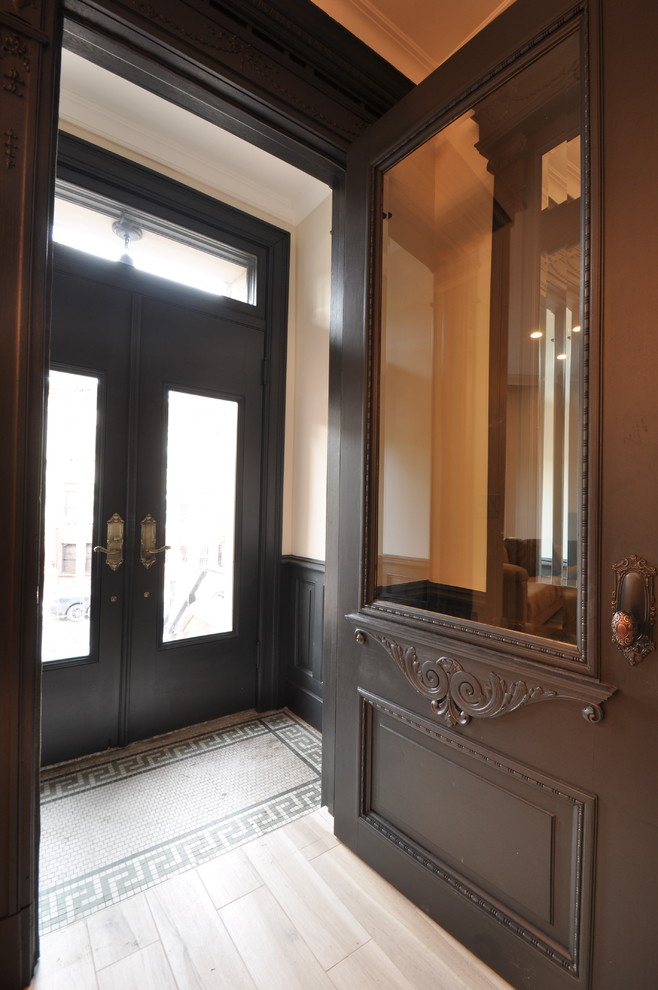 Design ideas for a small traditional front door in New York with beige walls, light hardwood floors, a single front door and a black front door.