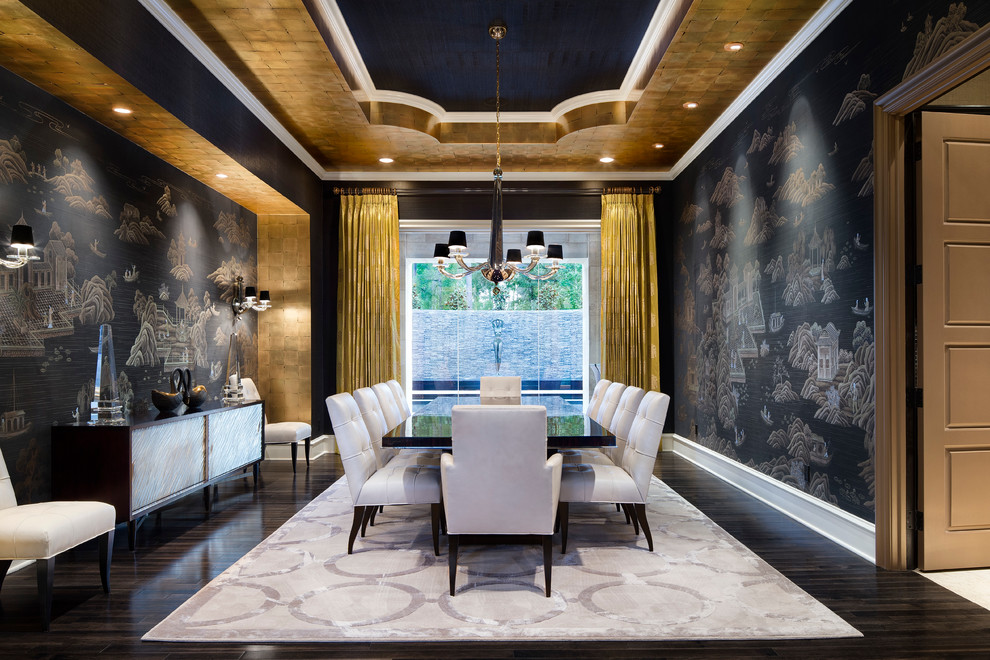 Expansive mediterranean separate dining room in Houston with dark hardwood floors and black walls.