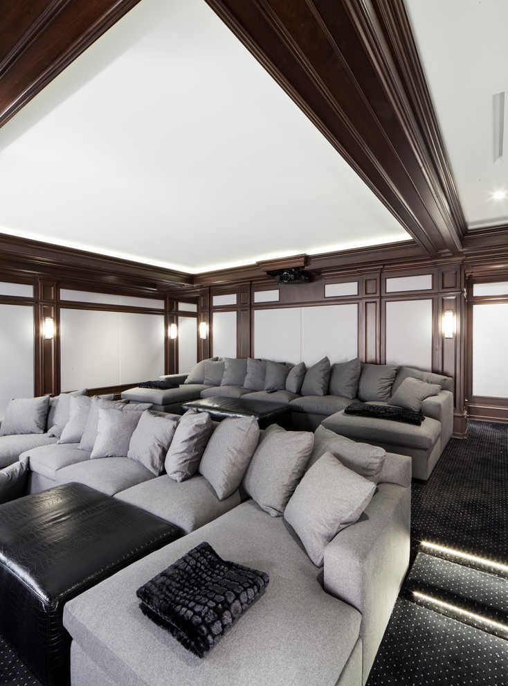 Design ideas for a mid-sized transitional enclosed home theatre in New York with carpet and a projector screen.