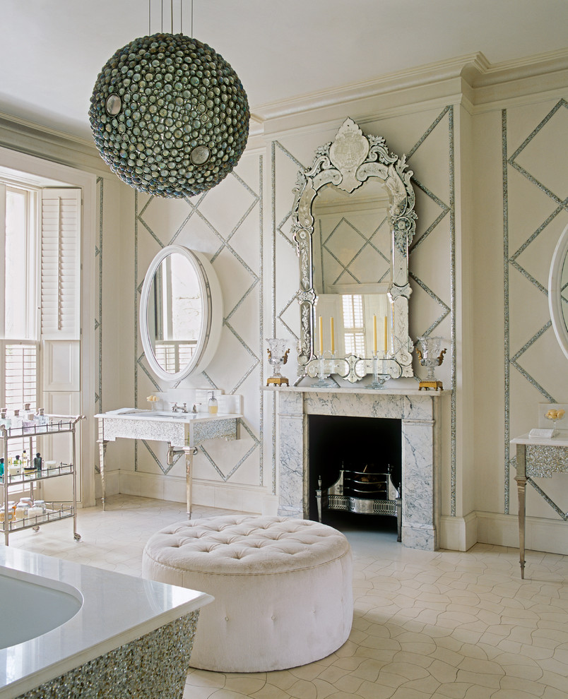 Inspiration for an expansive traditional master bathroom in London with a console sink and an undermount tub.