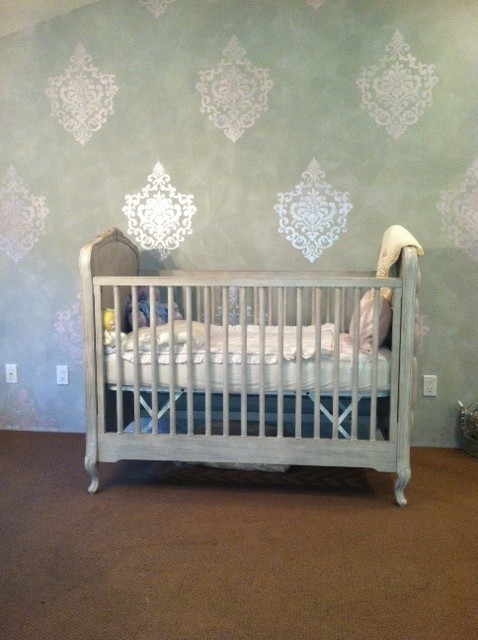 Small transitional nursery in Orange County with grey walls for girls.