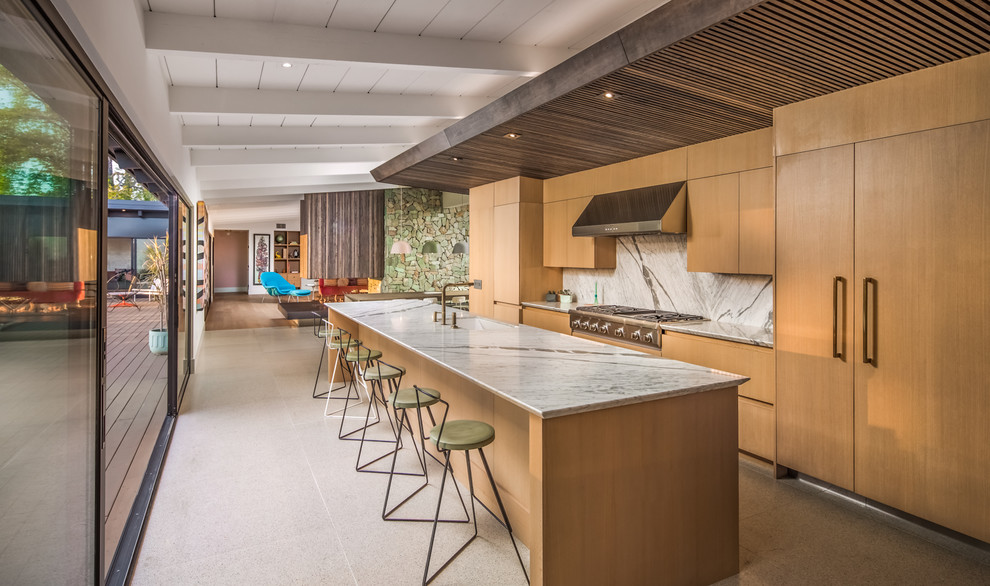 Design ideas for a midcentury galley kitchen in Miami with an undermount sink, flat-panel cabinets, medium wood cabinets, white splashback, stone slab splashback, panelled appliances, concrete floors, with island, grey floor and white benchtop.