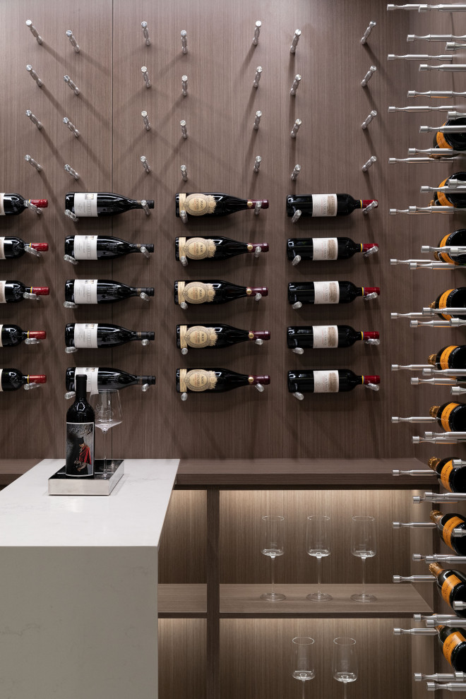 Design ideas for a small contemporary wine cellar in Vancouver with porcelain flooring, display racks and white floors.