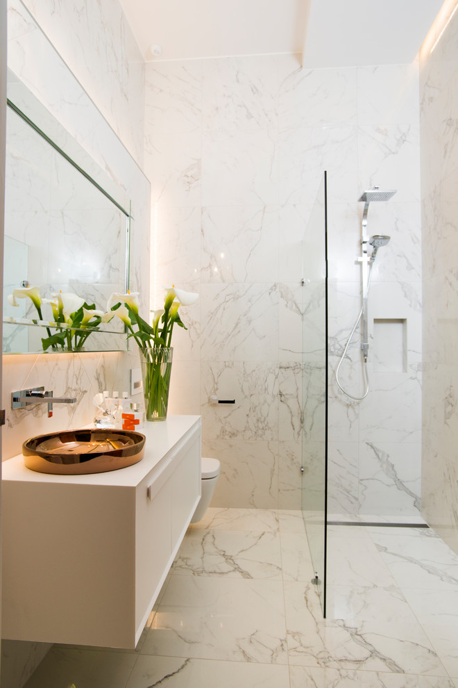 Inspiration for a small contemporary master bathroom in Adelaide with white cabinets, an open shower, a wall-mount toilet, white tile, porcelain tile, white walls, porcelain floors and white floor.